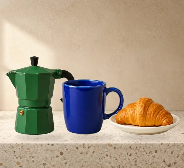 A coffee still life separated into a rebuilt terrazzo background and transparent moka pot, coffee mug, and croissant layers